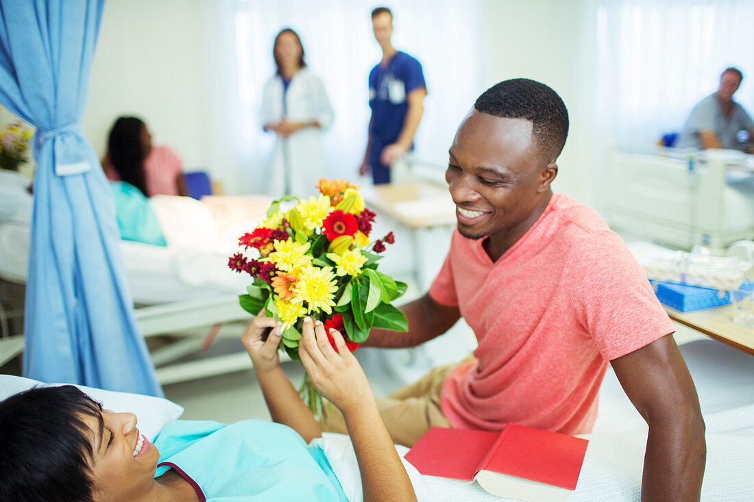 Man giving girlfriend bouquet of flowers