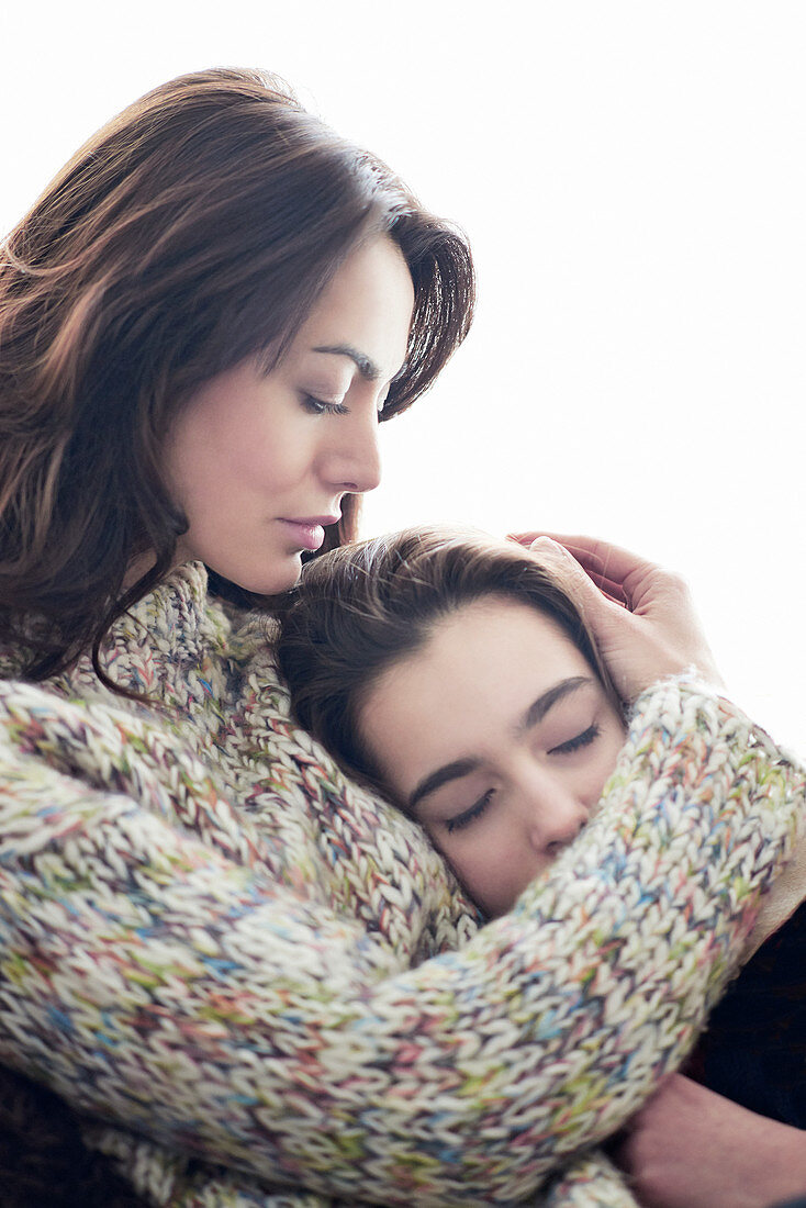 Mother hugging daughter