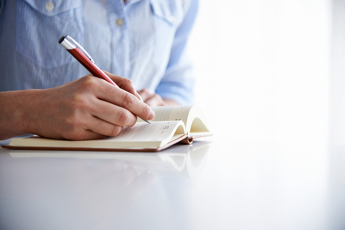 woman writing in notebook