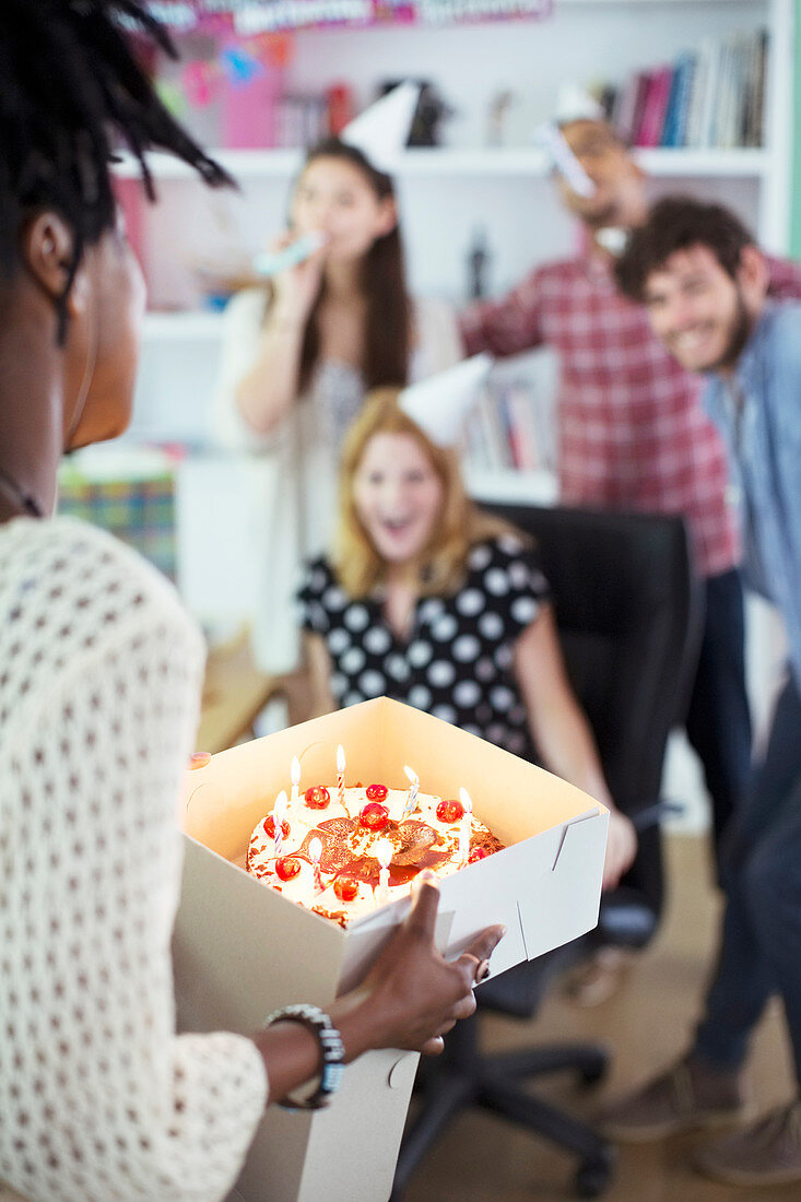 People celebrating birthday in office