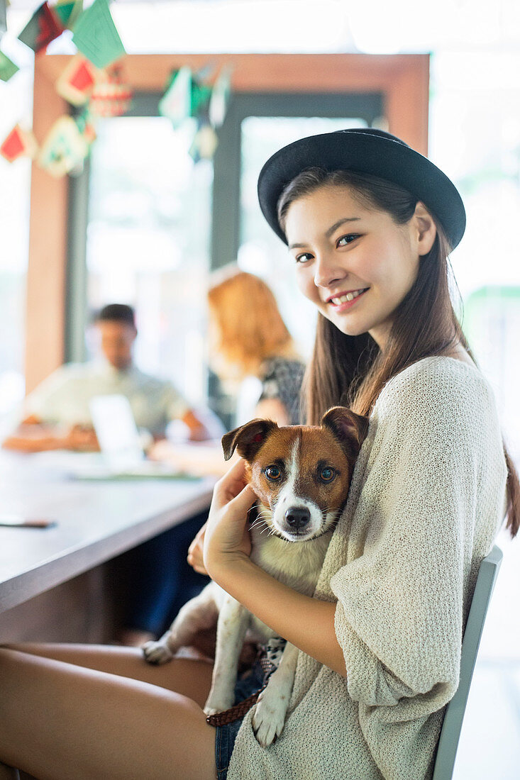 People holding dog at conference table