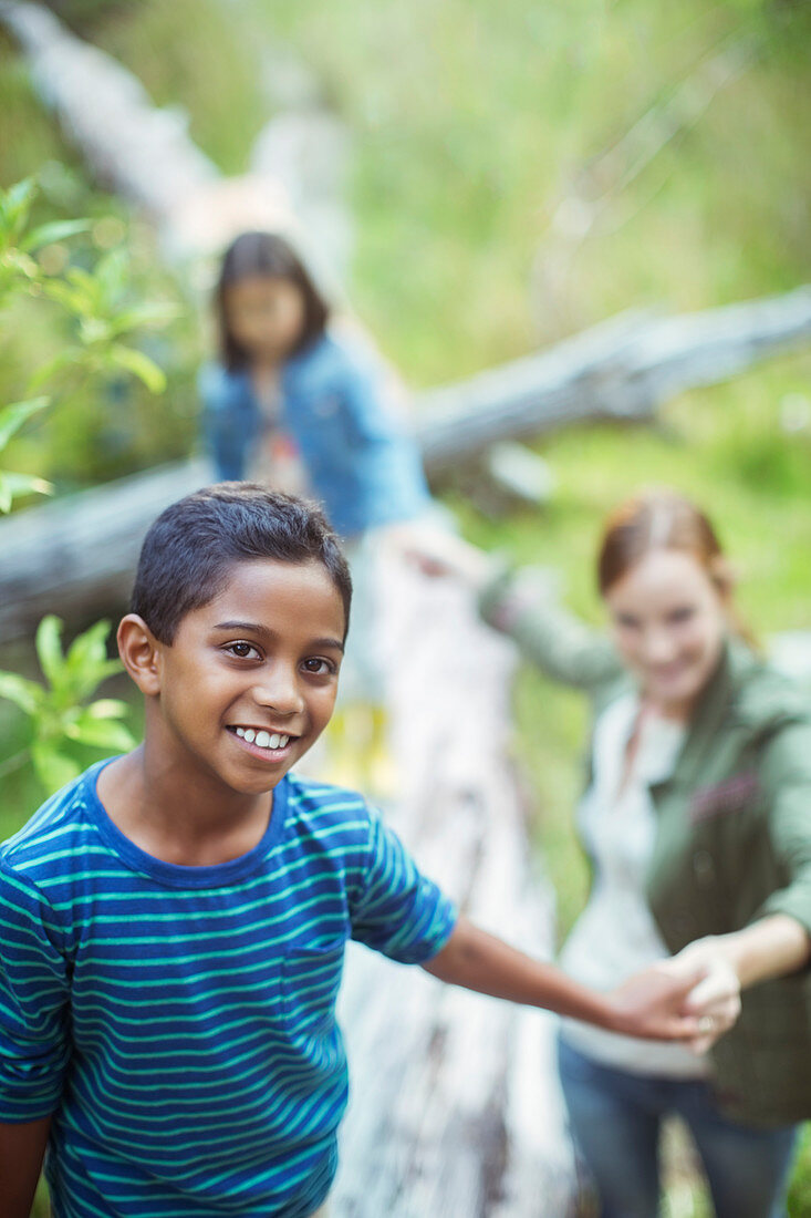 Students and teacher walking in forest