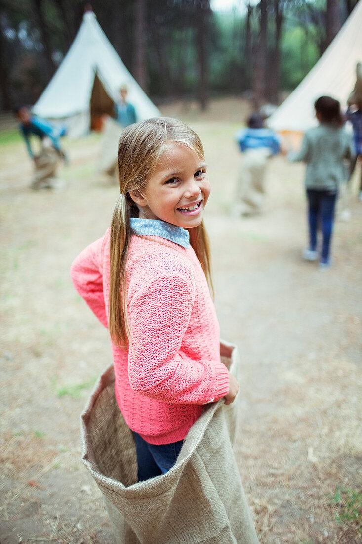 Girl smiling in sack at campsite