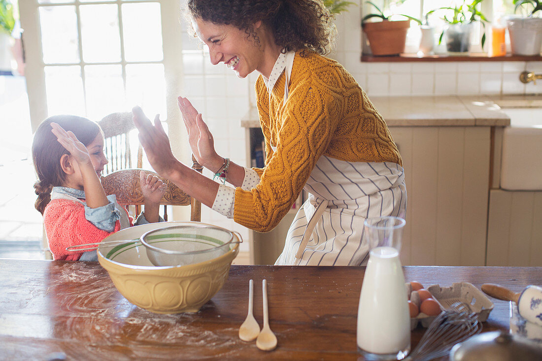 Mother and daughter high fiving