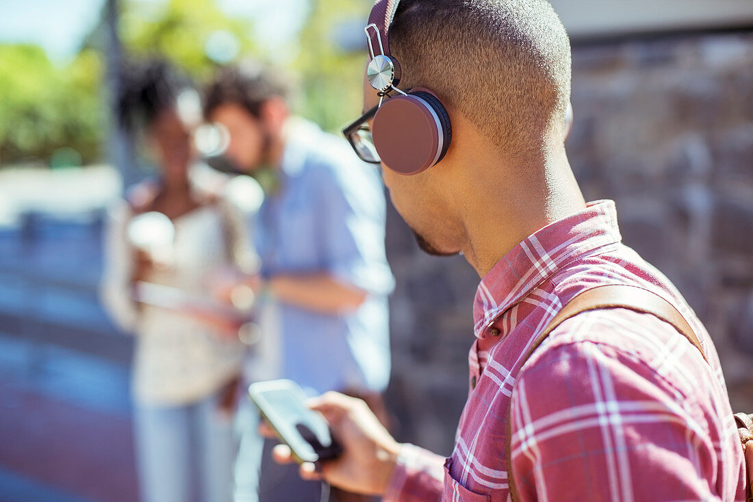 Man listening to mp3 player outdoors
