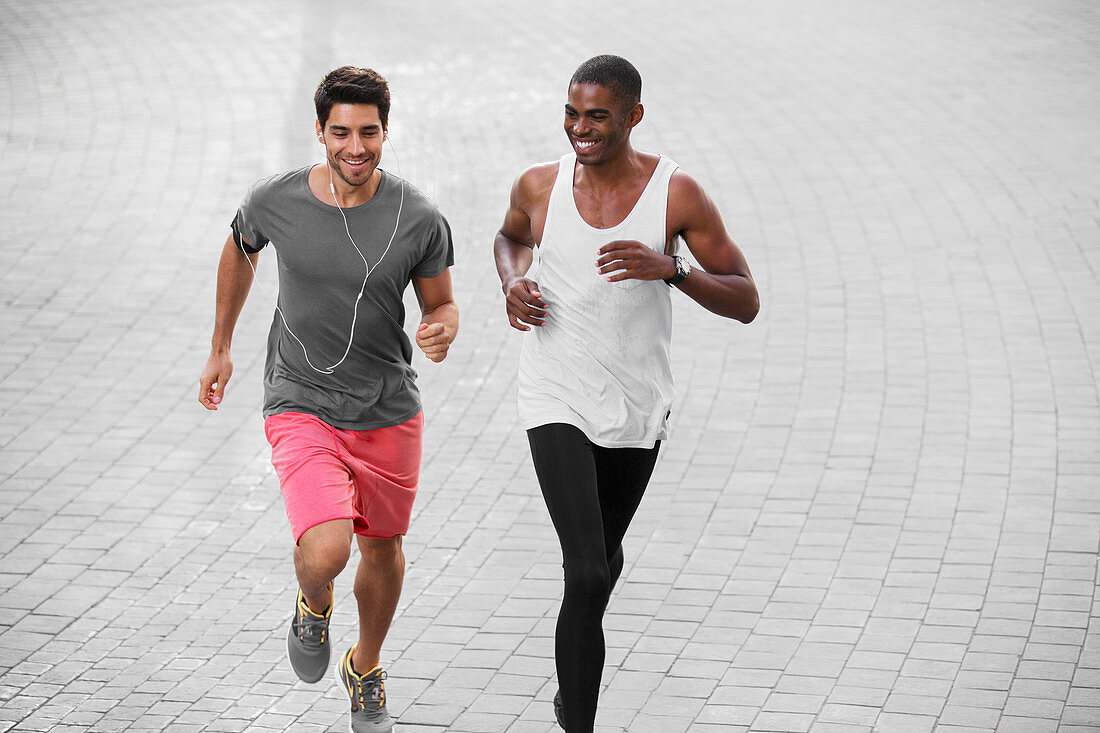 Men running through city streets together