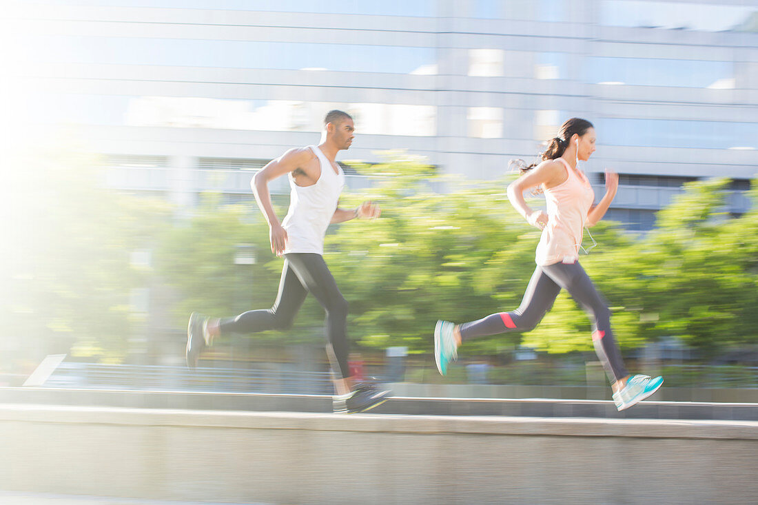 Couple running through city streets