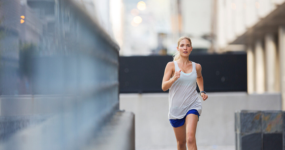 Woman running through city streets