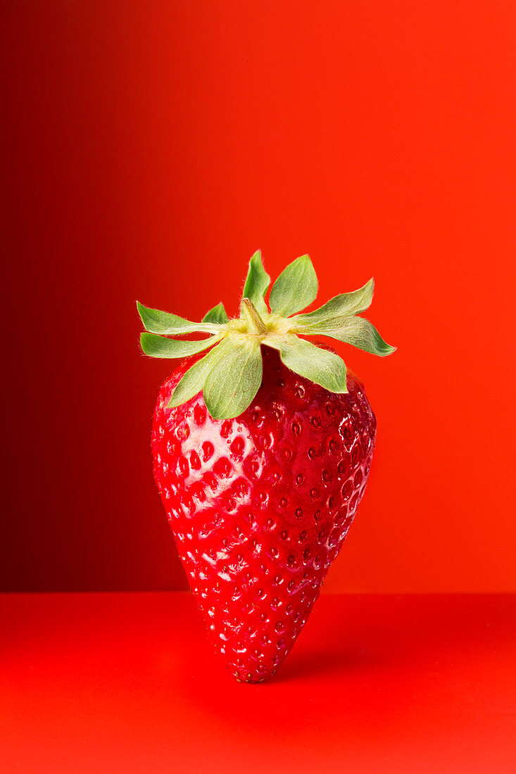 Strawberry on red counter