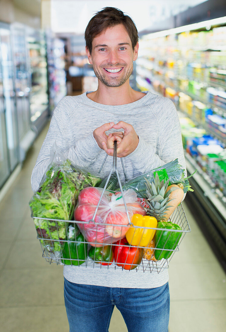 Man holding full shopping basket