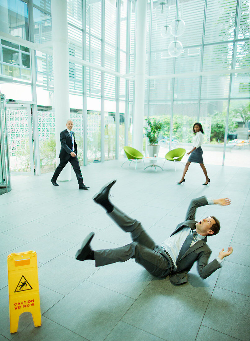 Businessman slipping on floor