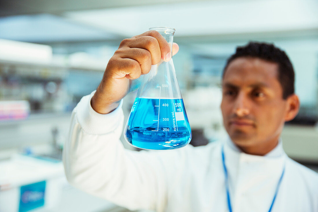 Scientist examining sample in beaker