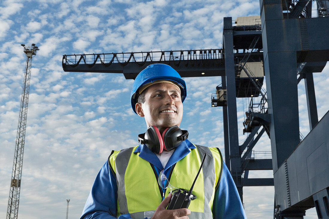 Worker smiling near cargo crane