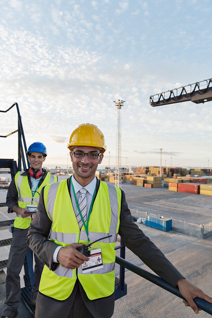 Businessman smiling on cargo crane