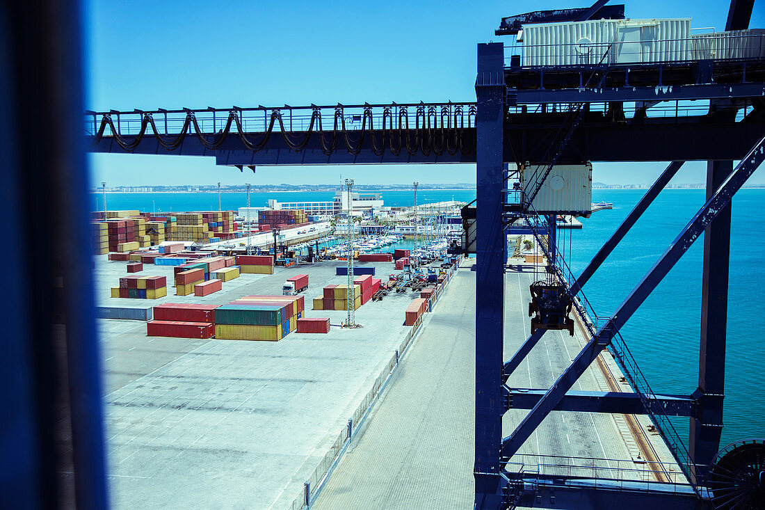 Crane and cargo containers at waterfront