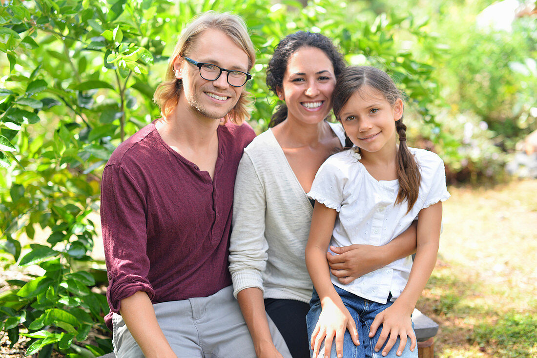 Portrait of smiling parents with daughter