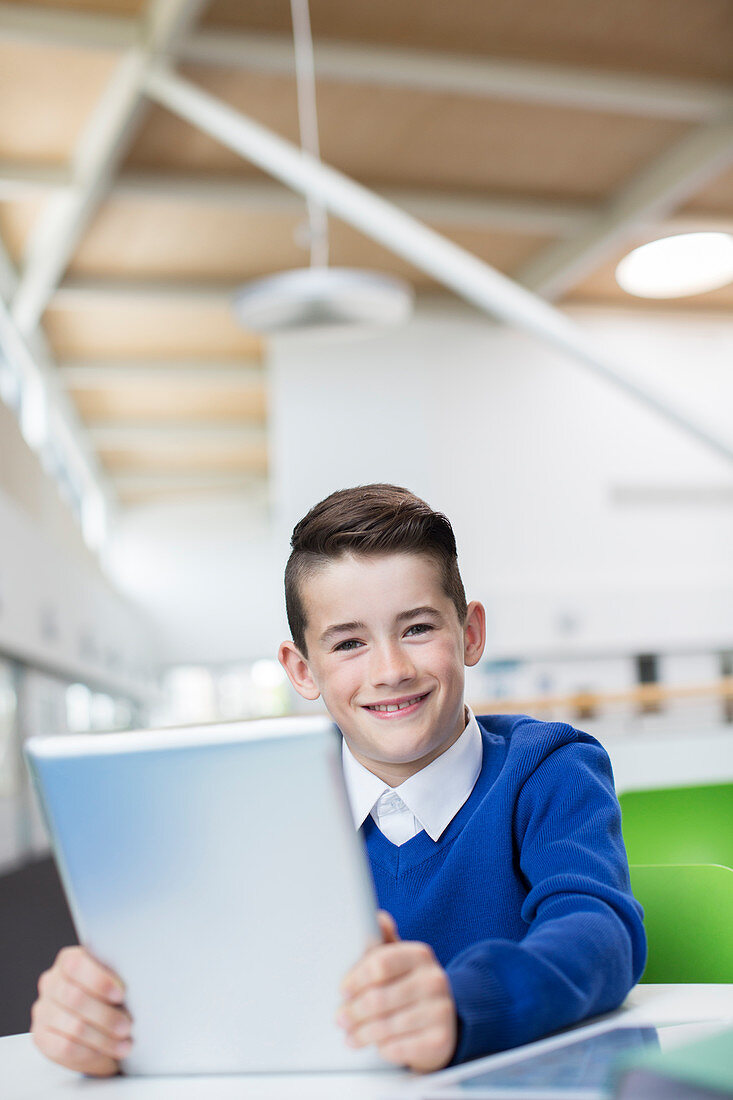 Smiling schoolboy with tablet pc
