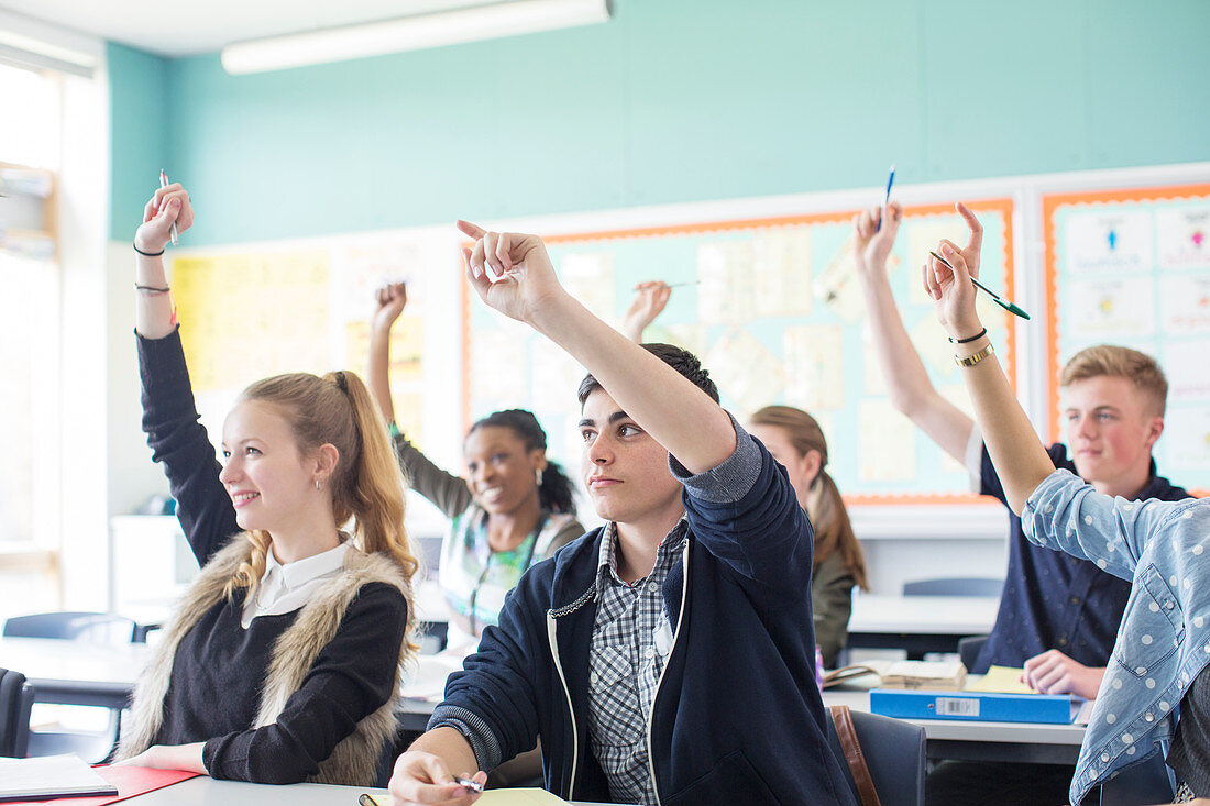 Students raising arms during lesson