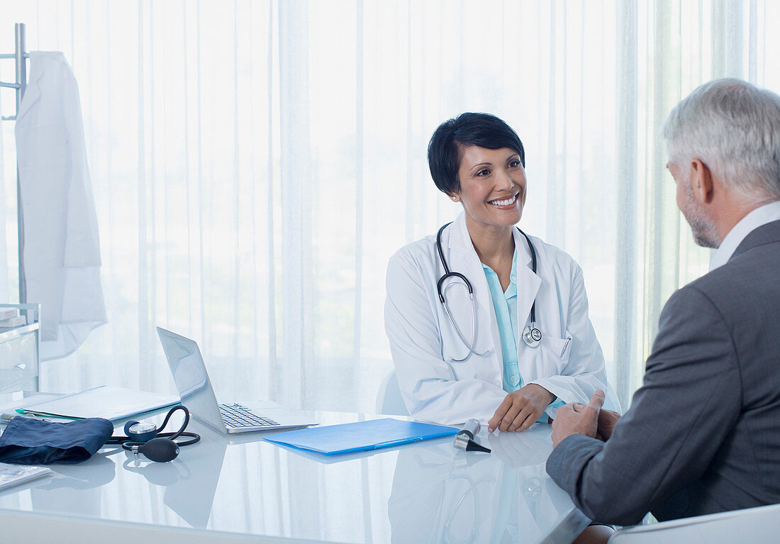 Smiling female doctor talking to patient