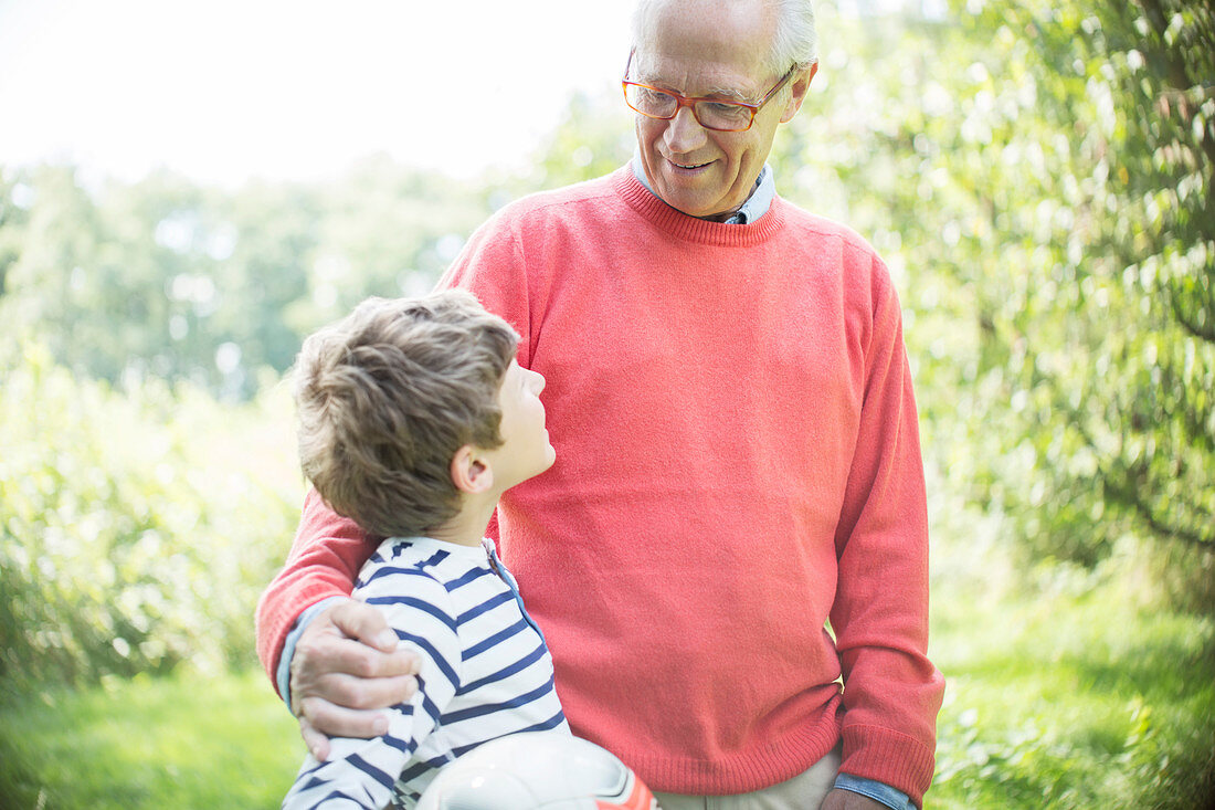 Grandfather and grandson hugging outdoors