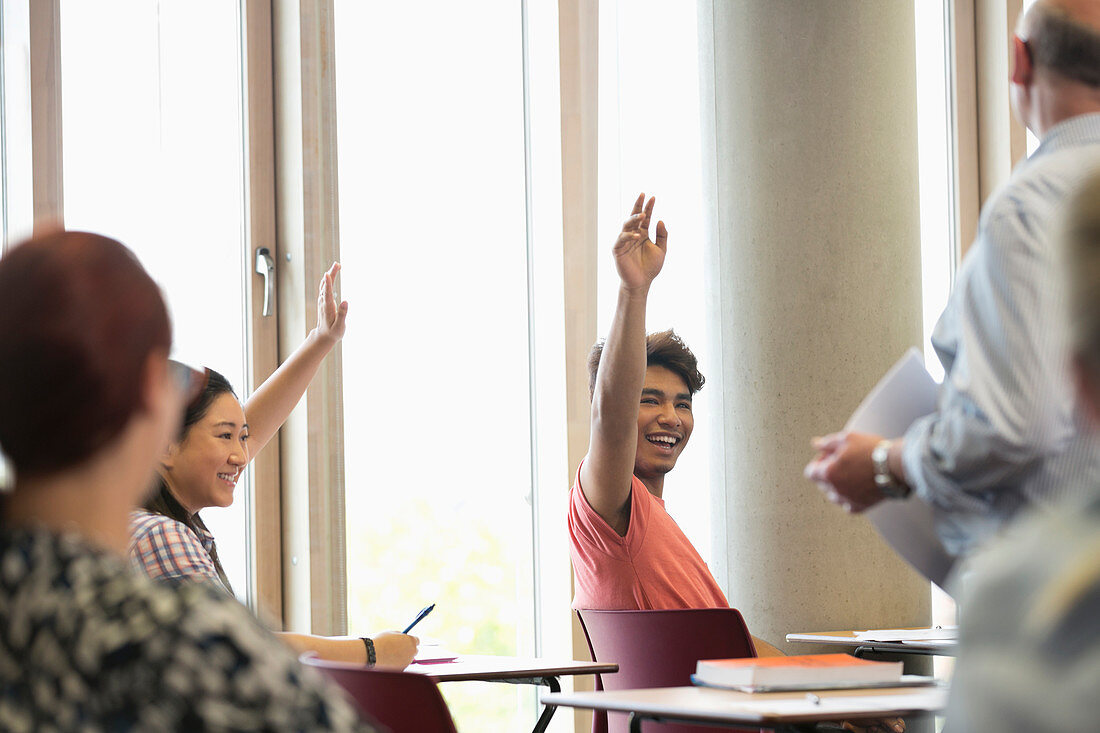 Students raising hands at seminar