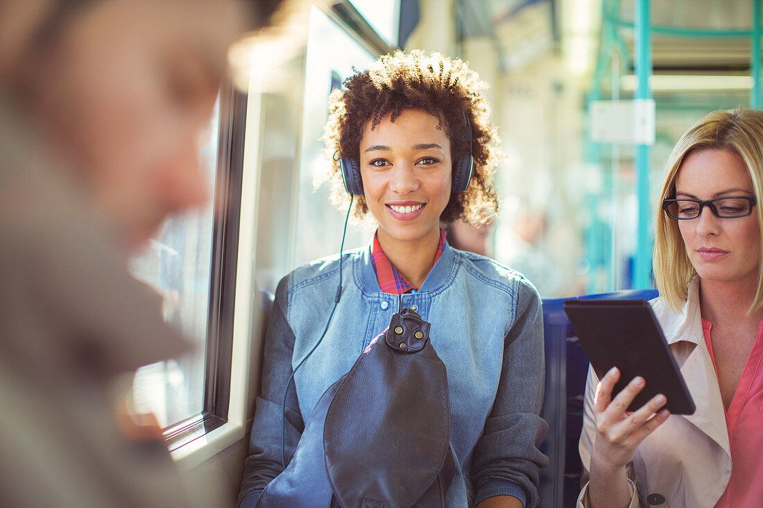 Woman listening to headphones on train