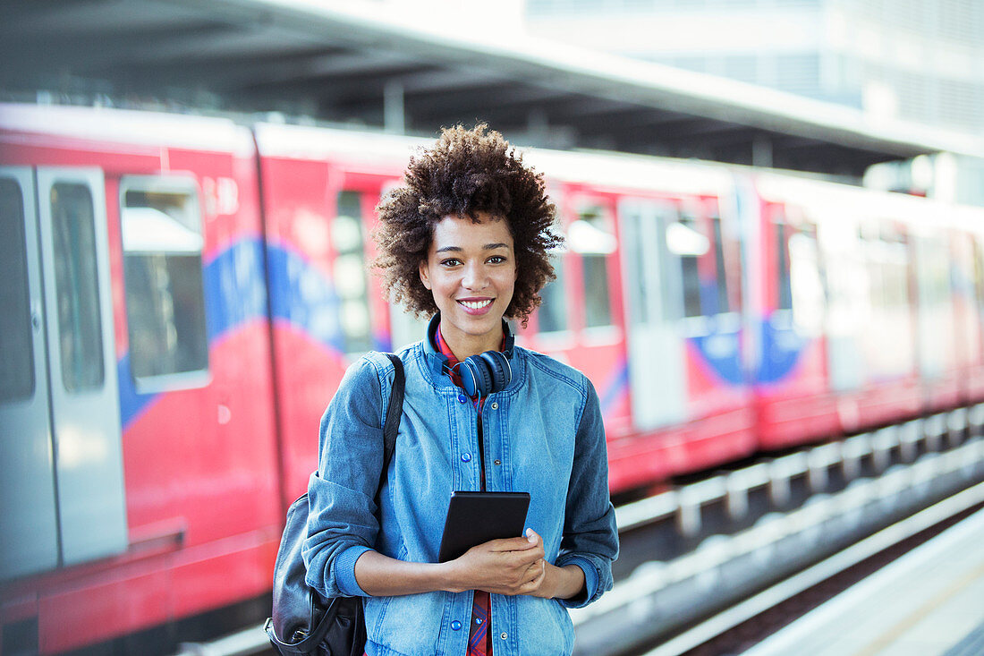 Smiling woman standing in train station