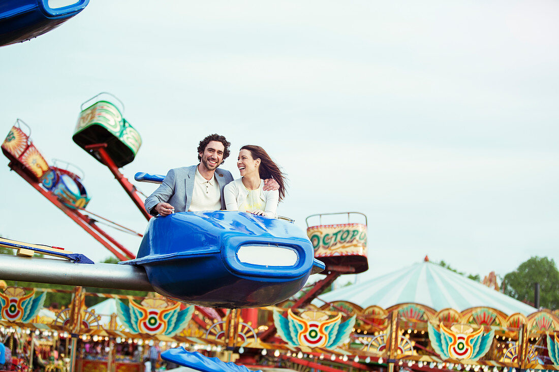 Couple enjoying ride on carousel