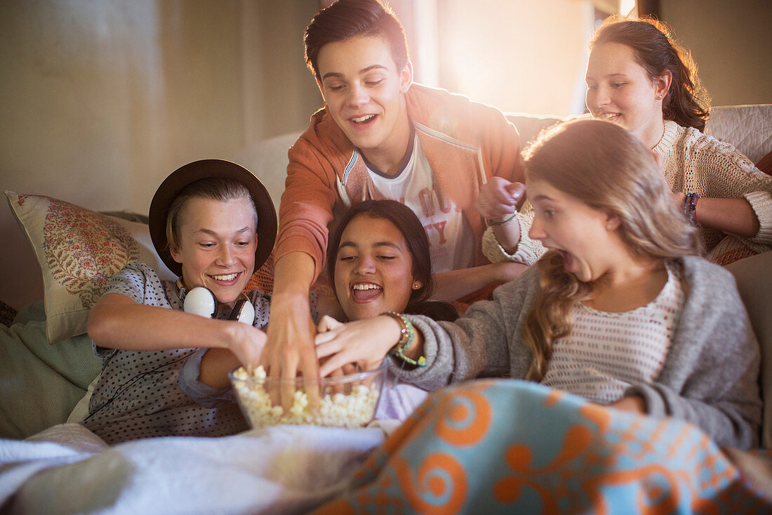 Group of teenagers eating popcorn