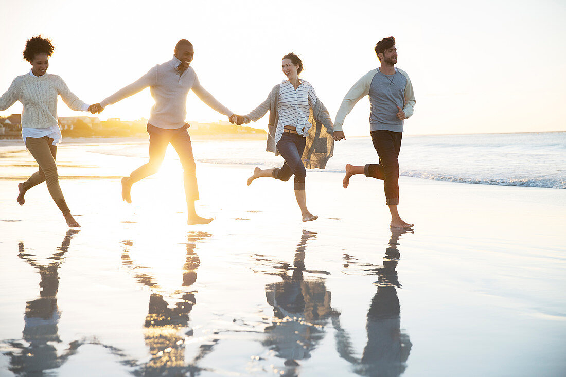 Group of four friends running