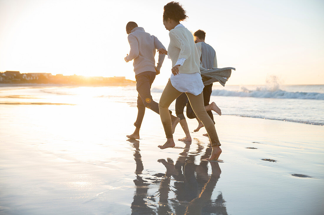 Four friends running in evening sun