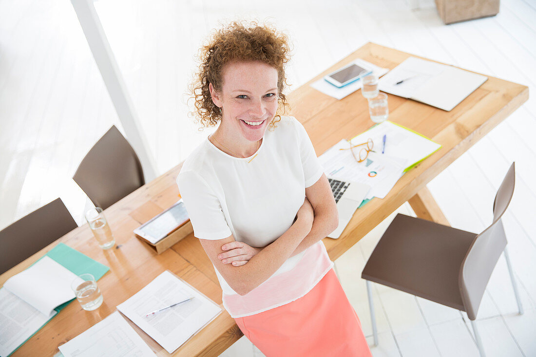 Woman with arms crossed, smiling