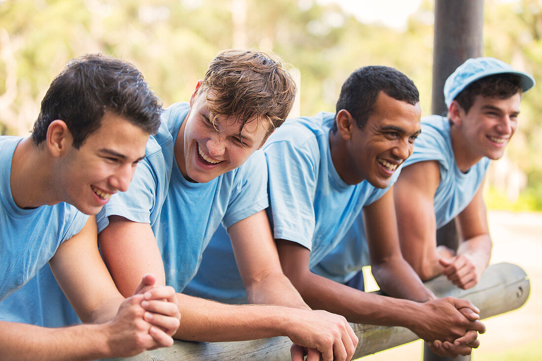 Smiling team leaning on railing