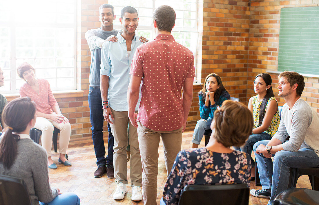 Supportive men at group therapy session