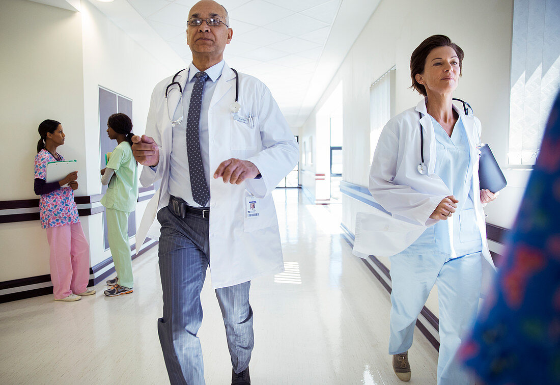 Doctors running down hospital corridor