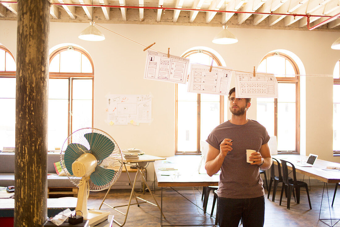 Businessman reviewing hanging diagrams