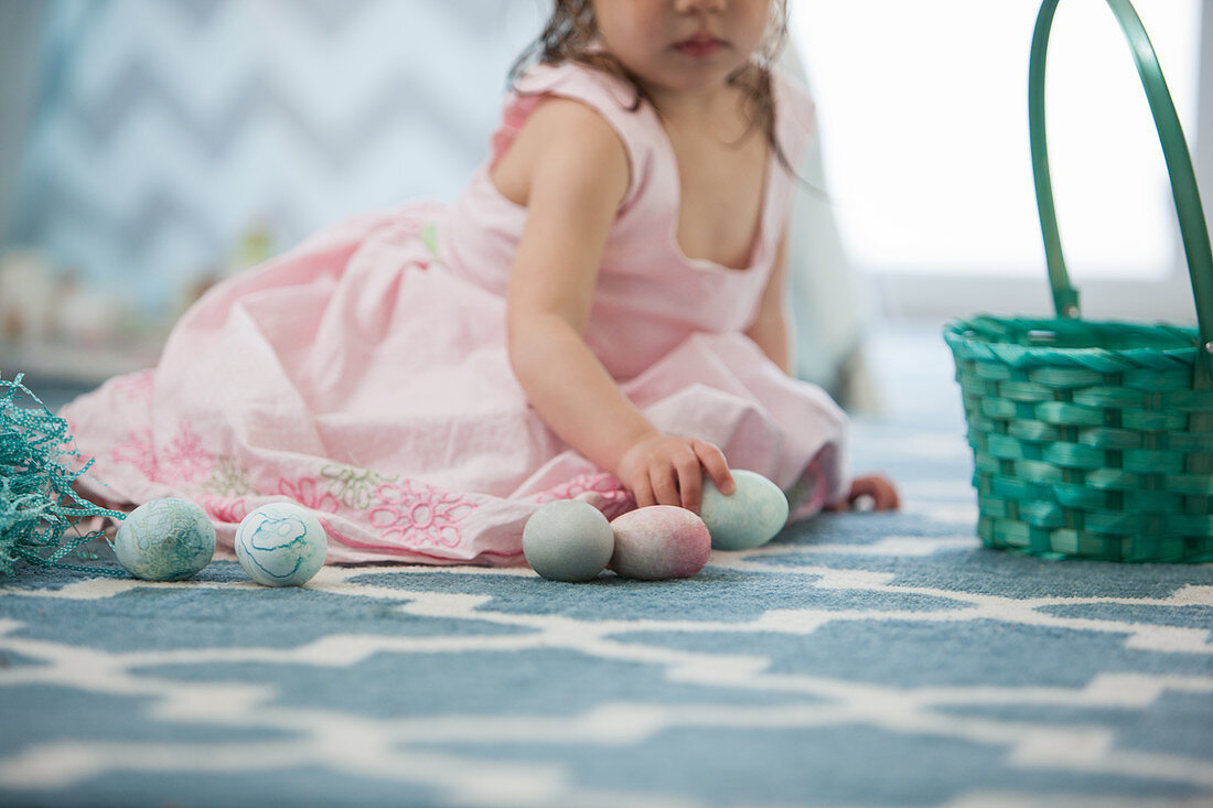 Girl in pink dress with Easter eggs