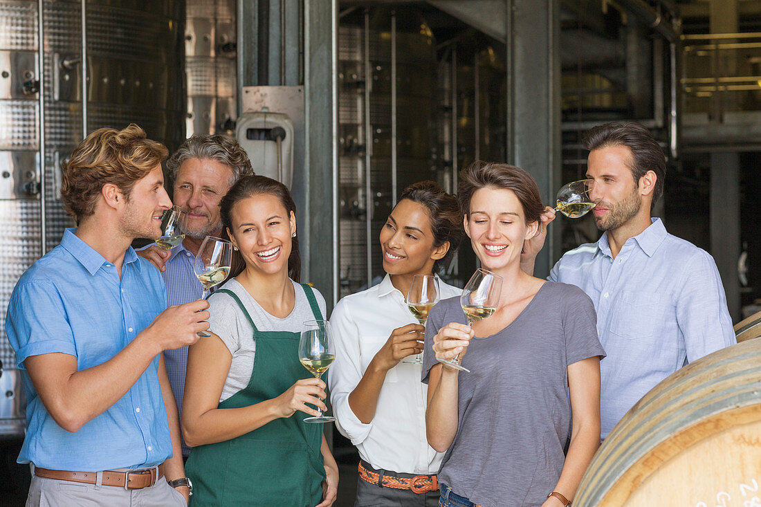 Winery employees tasting white wine