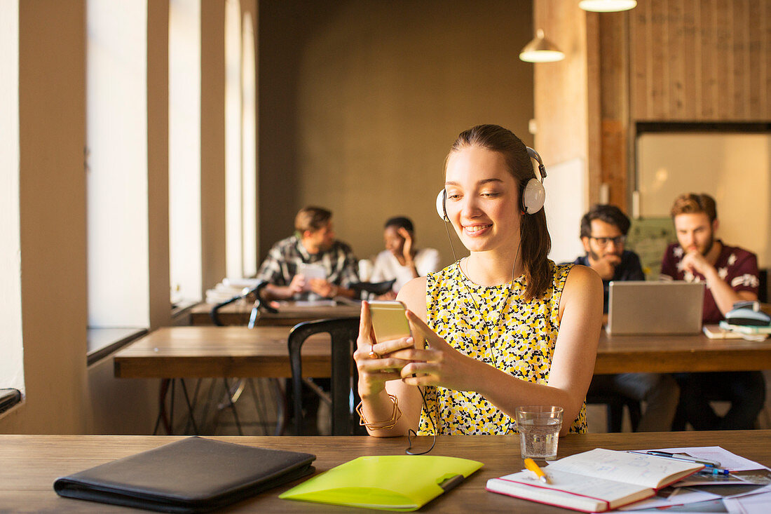 Businesswoman using cell phone in office