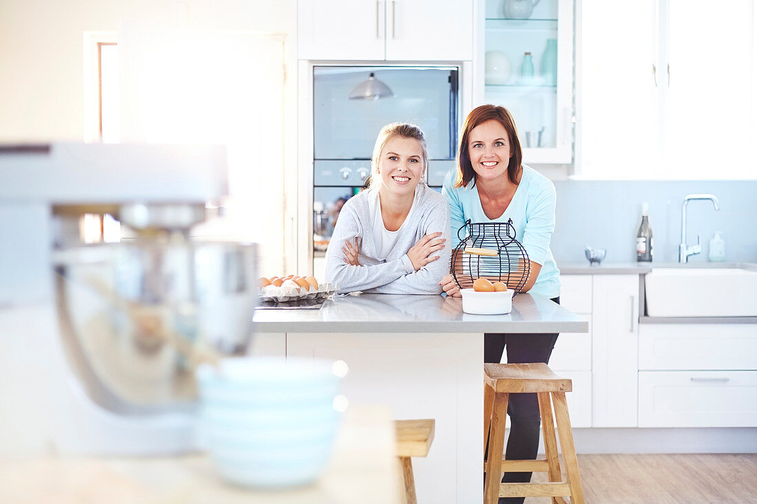 Women leaning on kitchen counter