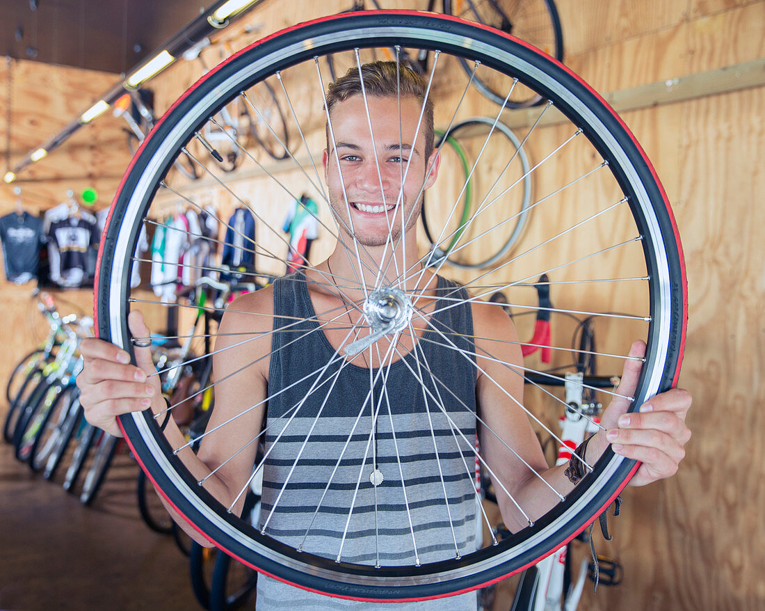 Man holding bicycle wheel