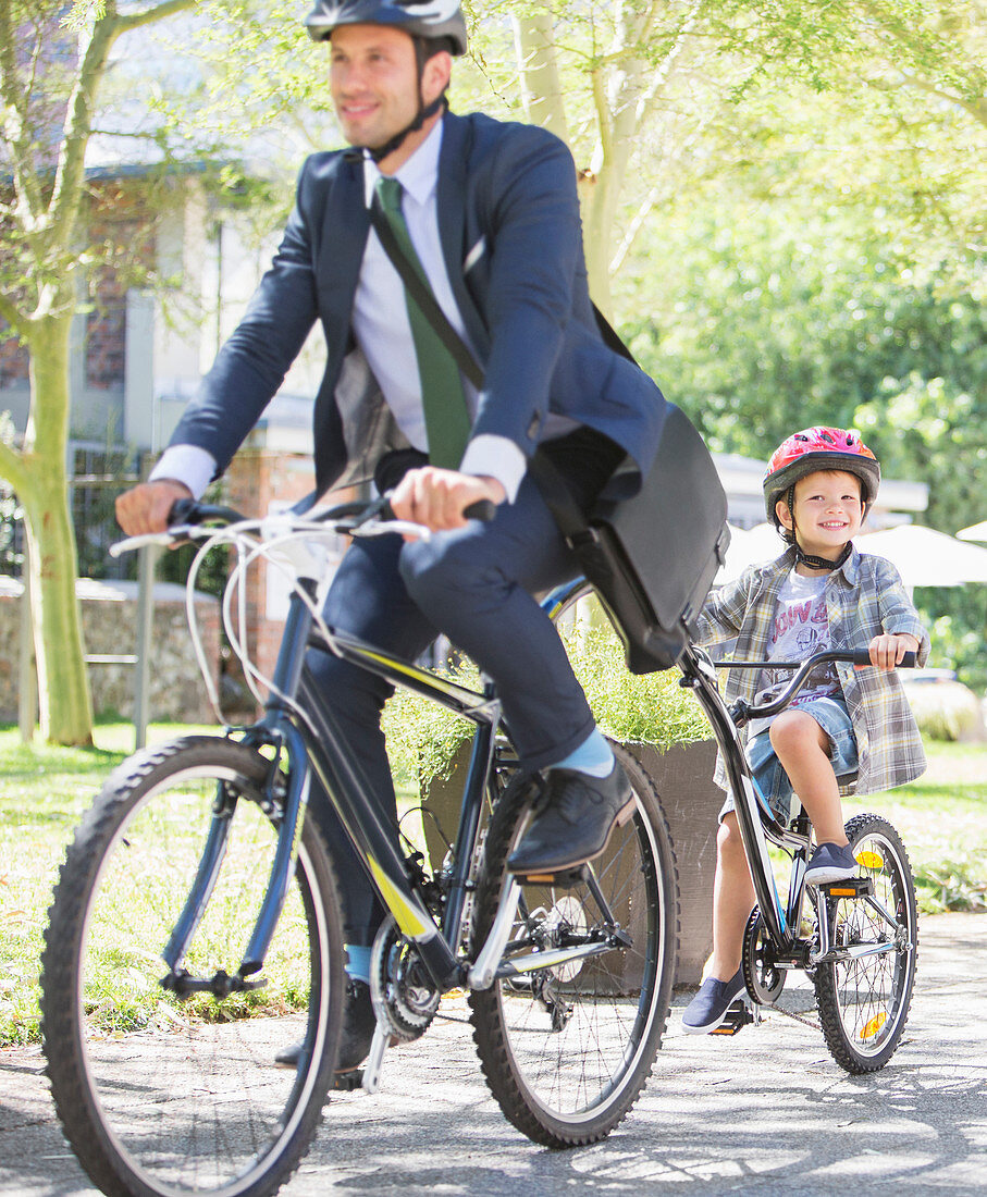 Businessman riding with son