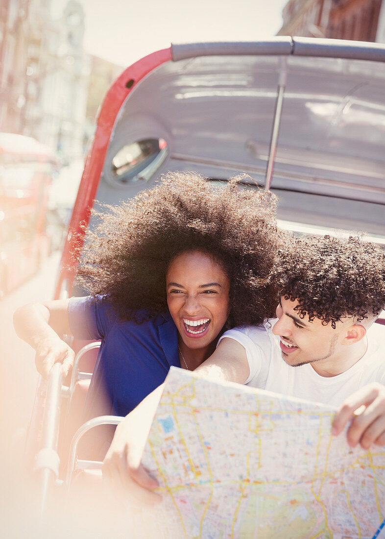 Enthusiastic couple with map