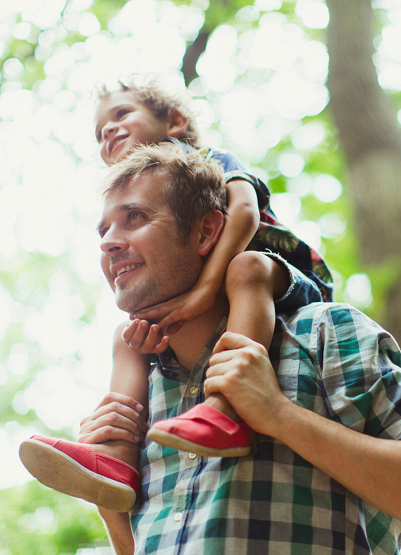 Father carrying son on shoulders