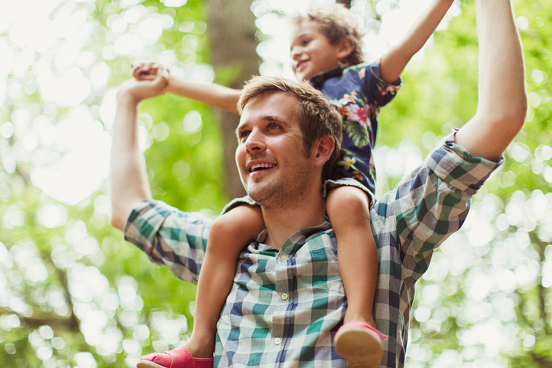 Father carrying son on shoulders