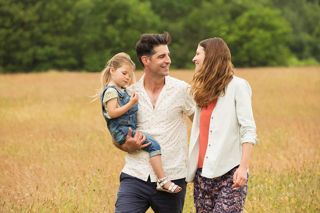 Family walking in rural field