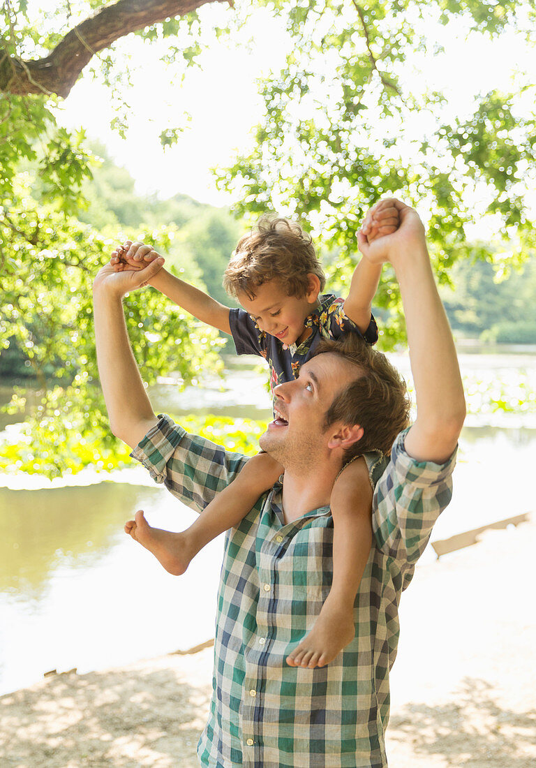 Playful father carrying son