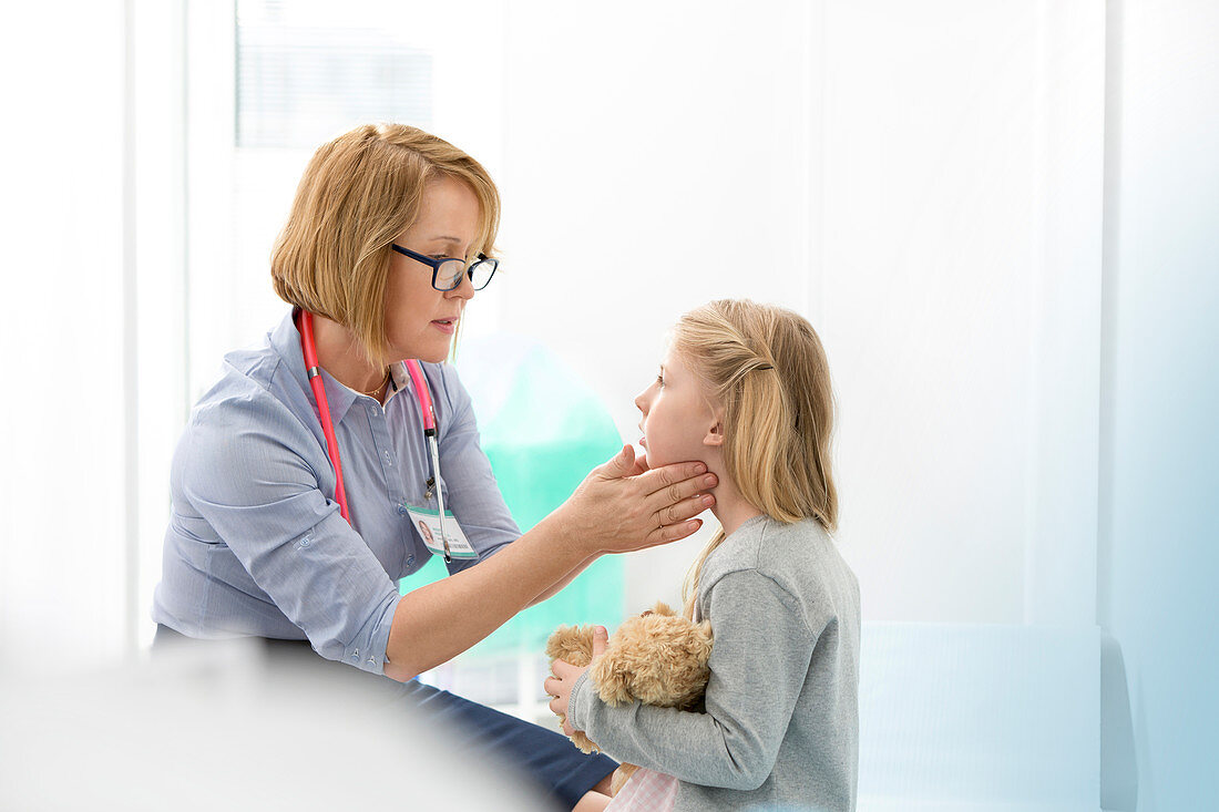 Pediatrician checking patient's glands