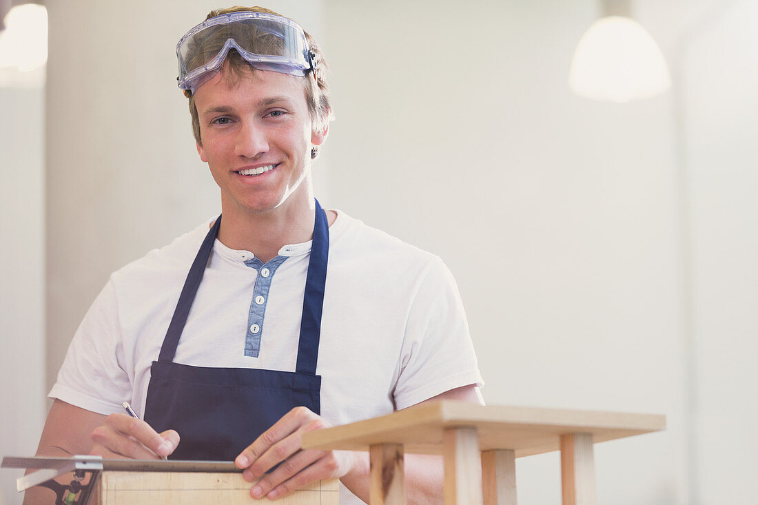 Portrait smiling carpenter in workshop