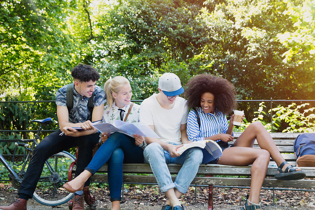 College students studying on park bench